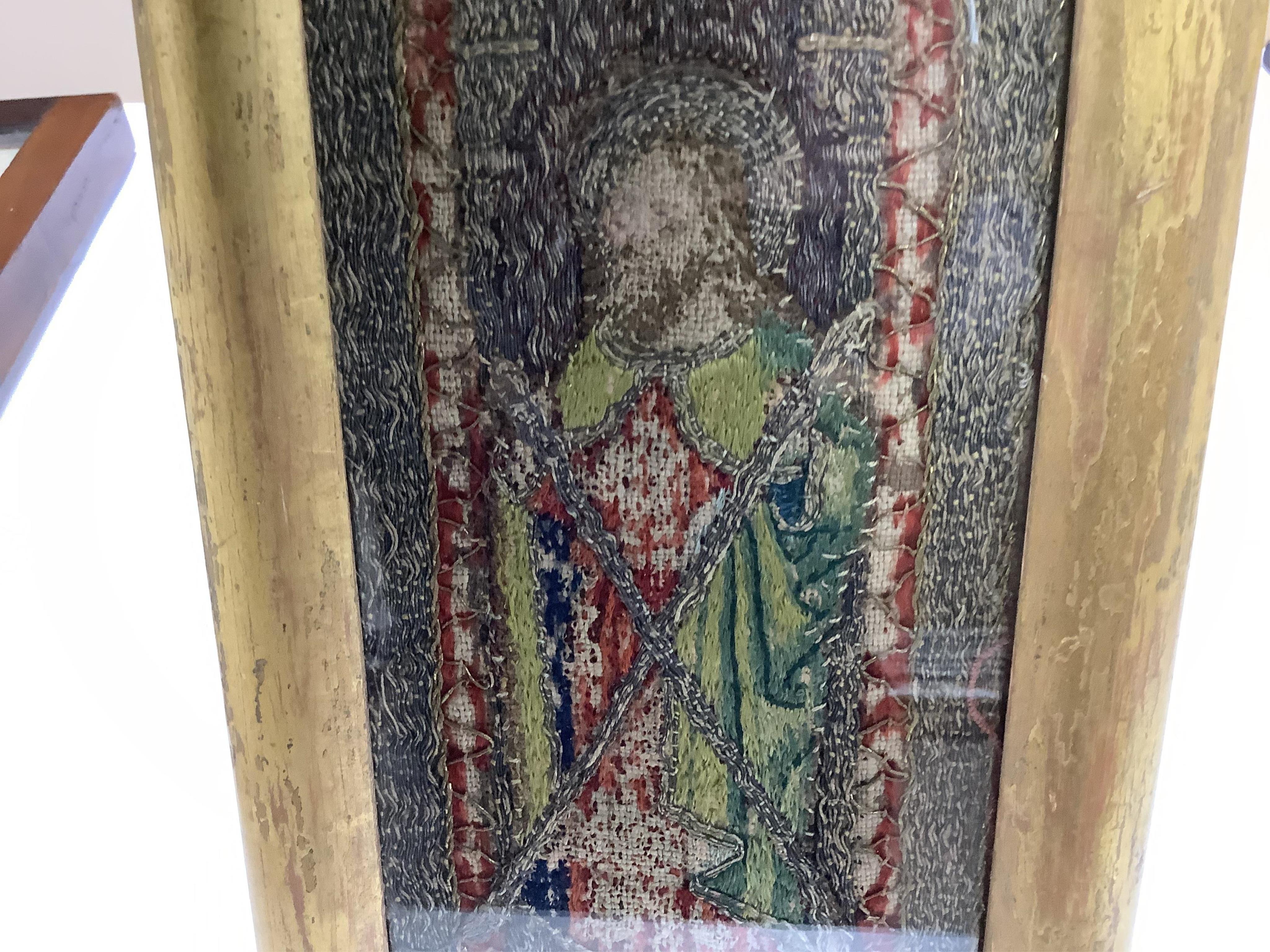 An early 16th century ‘Opus Anglicanum’ (English work), silk and metal thread embroidered fragment, of Saint Andrew, possibly cut from an orphrey, later framed and glazed, 28.5cm high x 9.5cm wide. Condition - the silk t